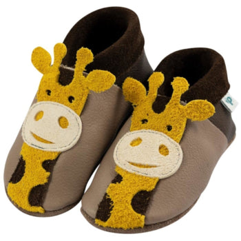 Baby slippers made of Ecopell leather with yellow giraffe faces on soft shoes.