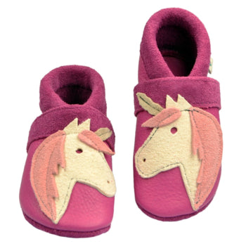 Baby slippers made of Ecopell leather with pink unicorn faces on soft shoes.