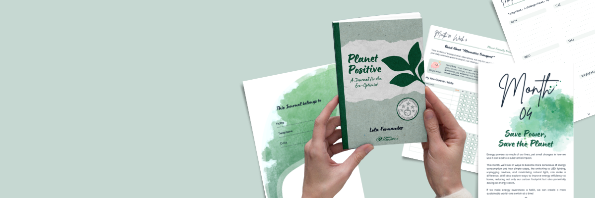 Hands holding the Planet Positive: A journal for the eco-optimist book on a background of pages from the book