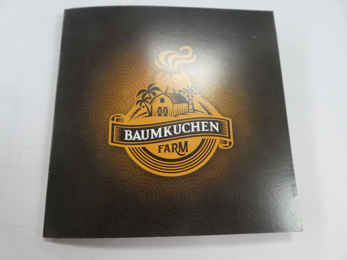 Baumkuchen Farm brochure—sleek black cover with golden logo