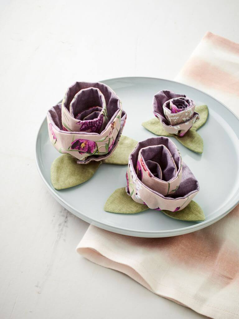 Three fabric roses handmade , placed on a plate as eco-friendly decoration from the book "Sustainähble".