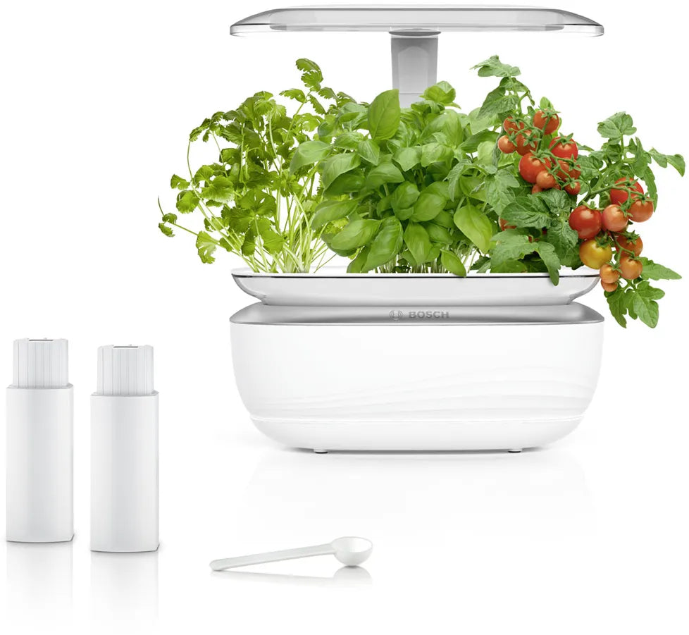 Bosch SmartGrow Life indoor hydroponic garden with herbs and tomatoes, compact self-watering system with LED light