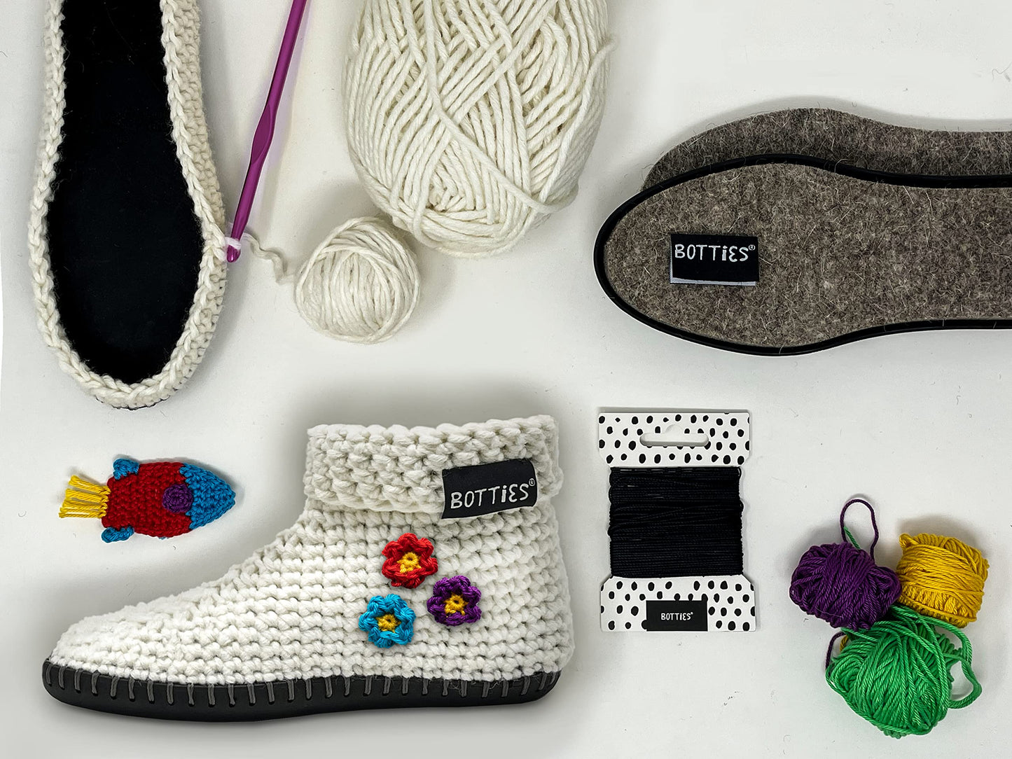 Botties crochet DIY shoe kit with wool slipper, black sole, yarn, needle, and decorative appliques