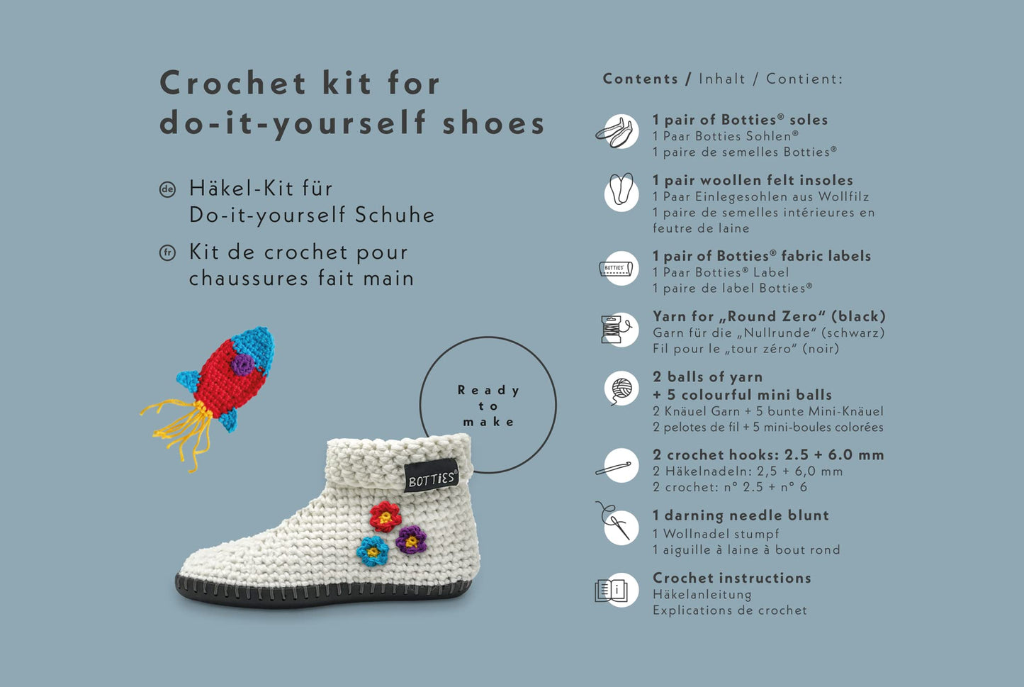 Crochet kit for DIY wool shoes by Botties, featuring a handmade slipper with a black sole, yarn, crochet hooks, and colorful appliques and instructions