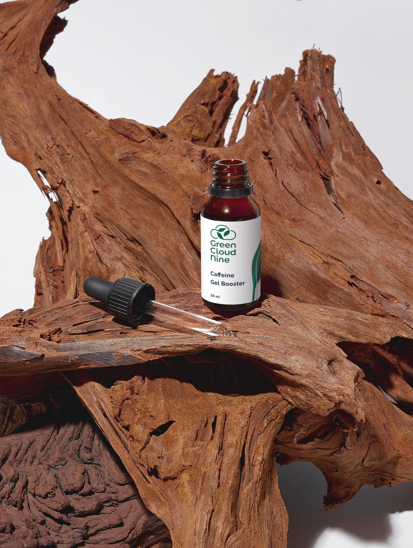 Green Cloud Nine Caffeine Gel Booster with dropper standing on drifted wood