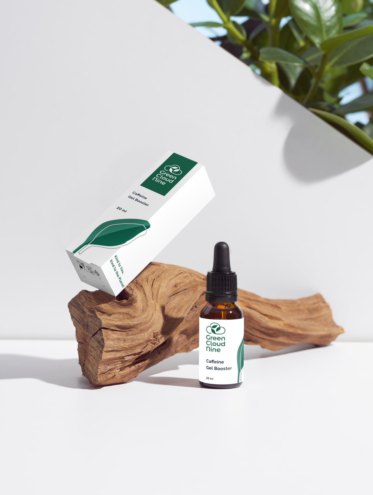 Caffeine Gel Booster glass dropper bottle with Green Cloud Nine logo on a white background with plants, displayed on wood