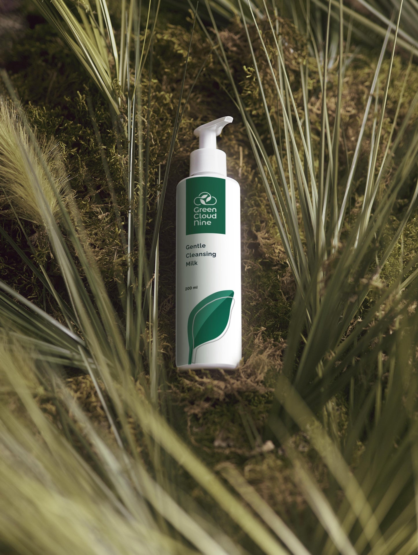 Cleansing milk bottle pump with green cloud nine logo on a natural background (front)