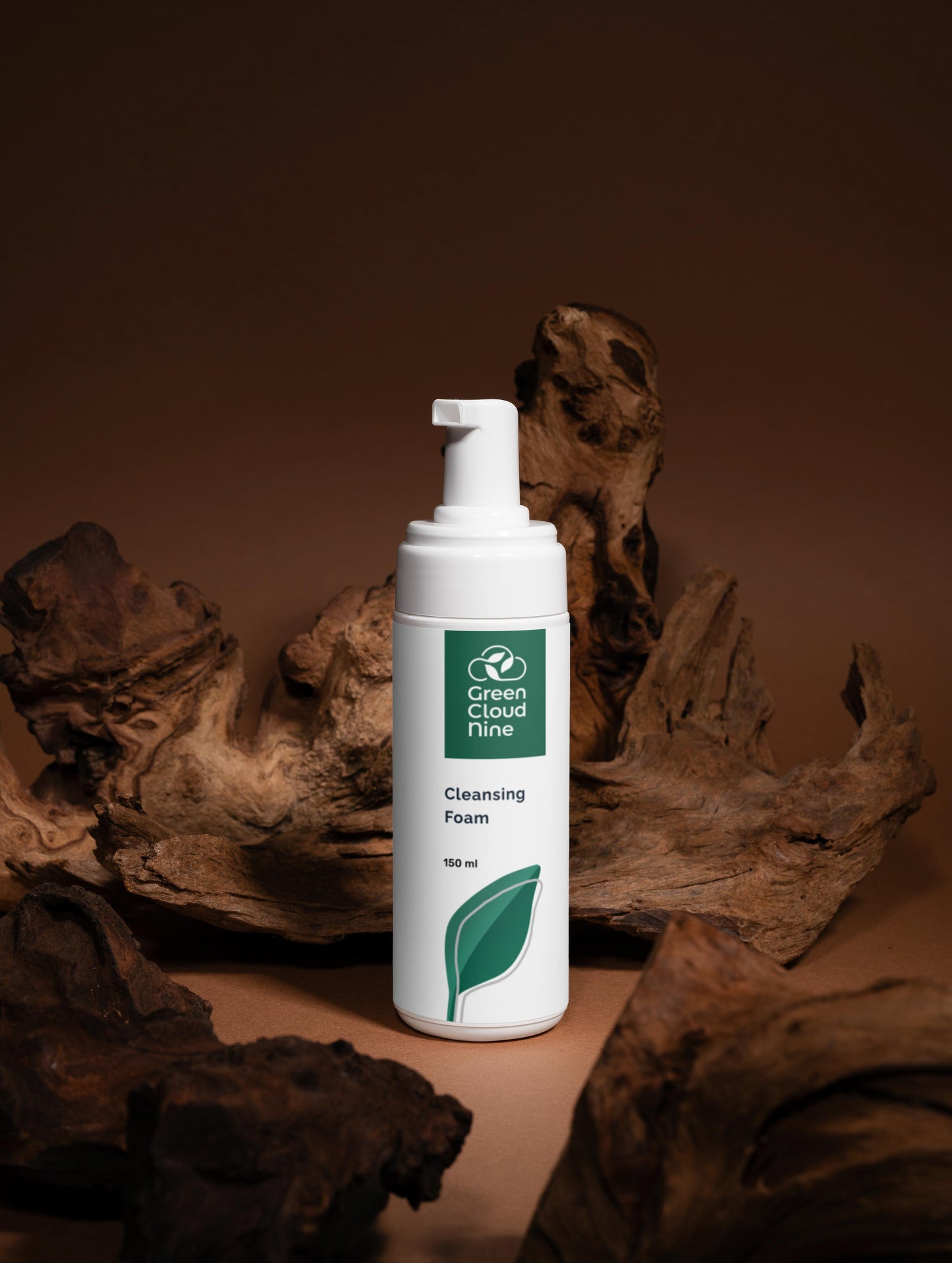 White bottle of Green Cloud Farm cleansing foam with a leaf logo on a brown background