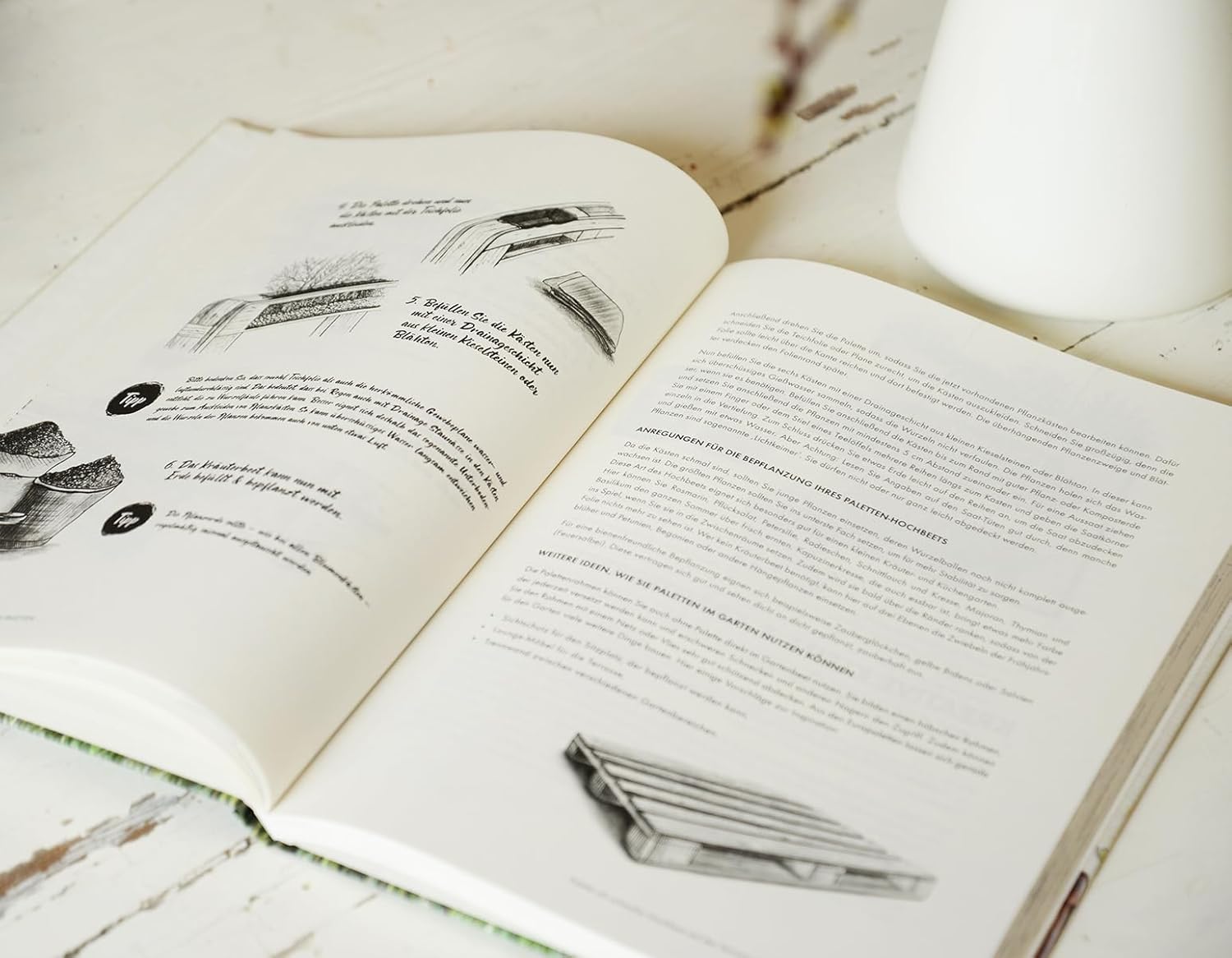 Open 'Der DIY Garten' with illustrations on a wooden surface