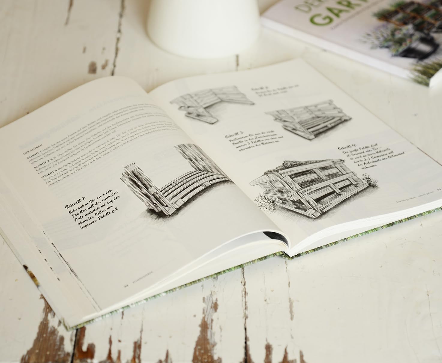 Open 'Der DIY Garten' with illustrations on a wooden surface