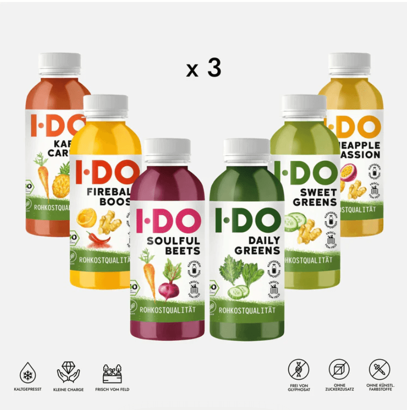 Set of six colorful I DO organic juice bottles, part of a 3-day cold-pressed vegan juice cleanse for energy and wellness.