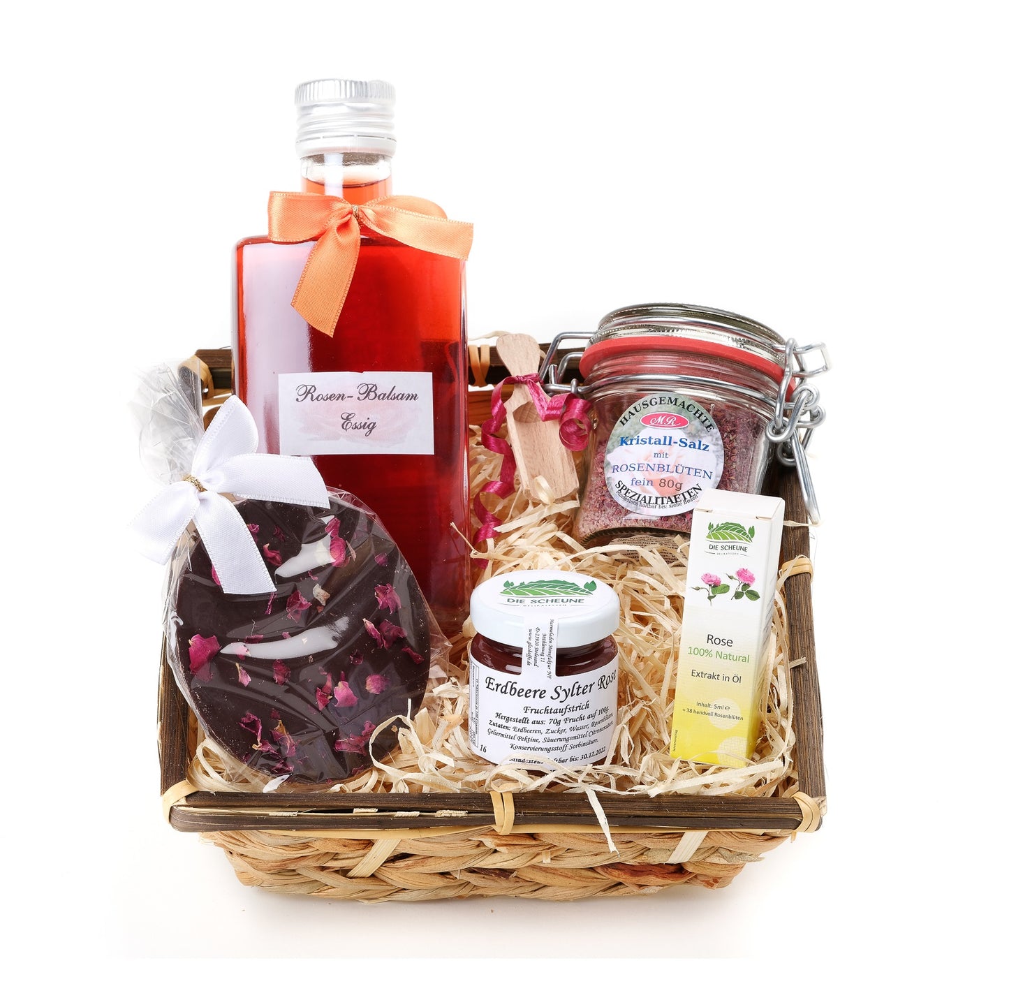 Gift basket with rose vinegar, rose salt, strawberry jam, rose oil, and rose chocolate on straw filling.