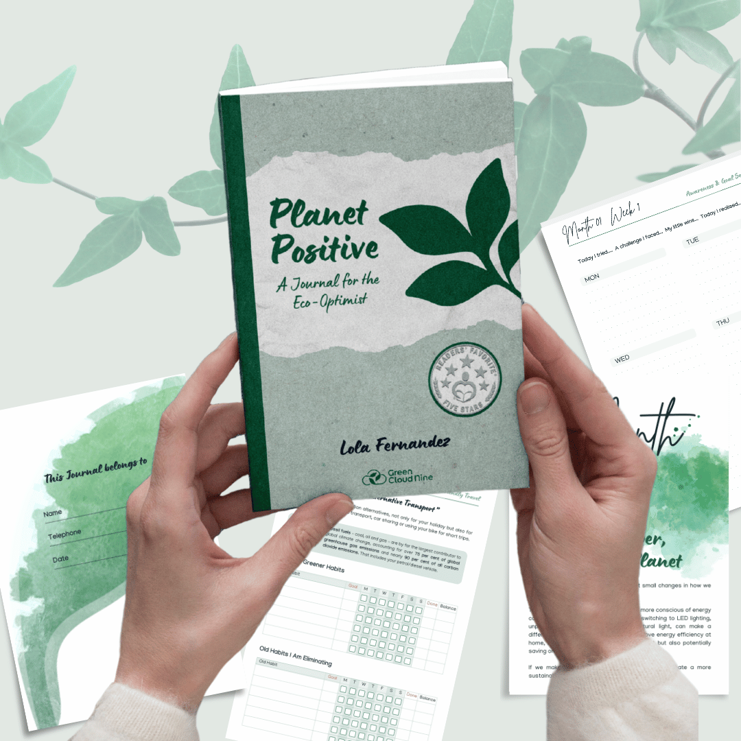 Hands holding the Planet Positive journal with eco-friendly content and planner pages displayed in the background.