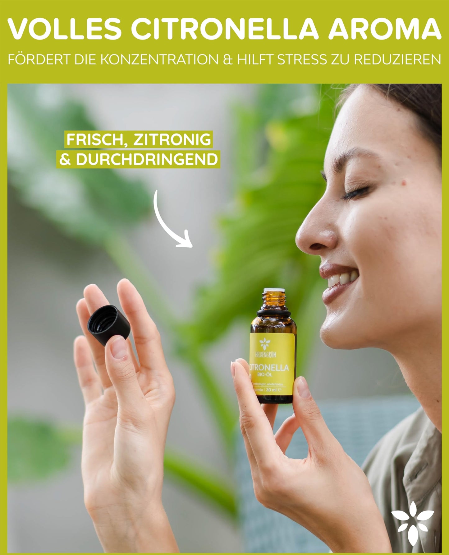 A woman holding a bottle of Heldengrun Organic Essential Oil 30ml citronella