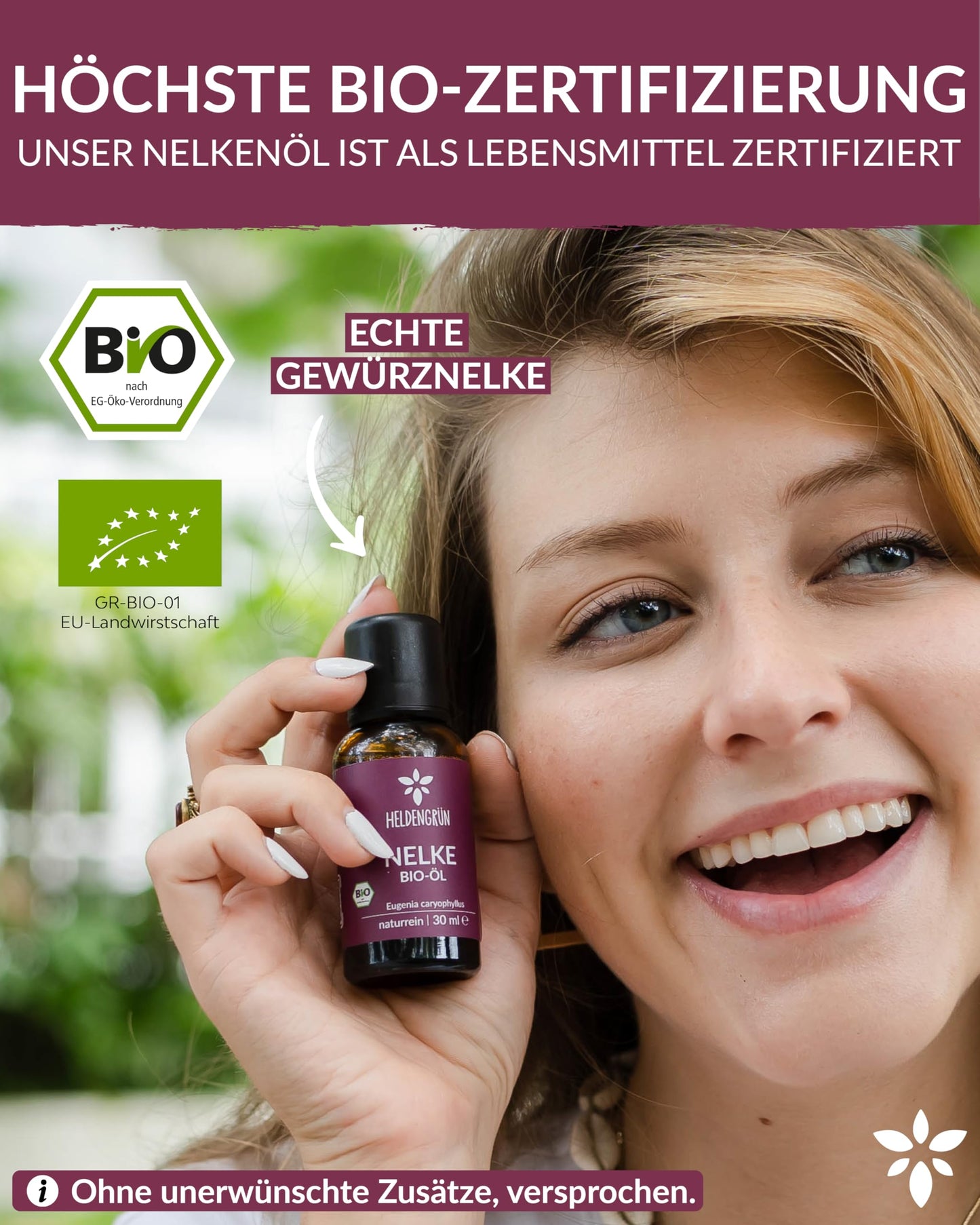 A woman holding a bottle of Heldengrun Organic Essential Oil 30ml nelke
