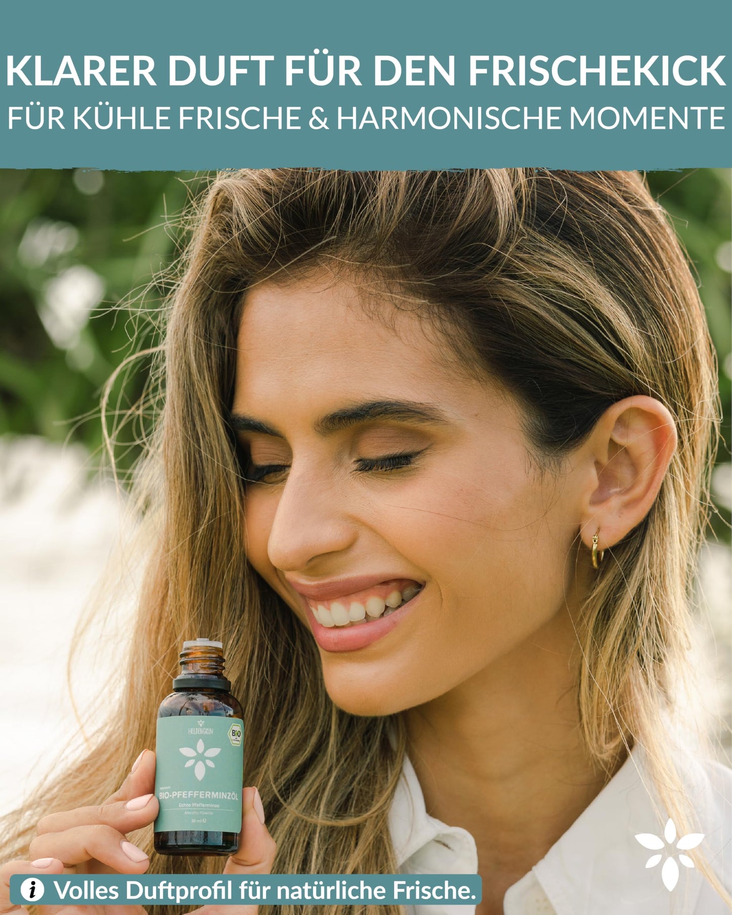 A woman holding a bottle of Heldengrun Organic Essential Oil 30ml pfefferminze