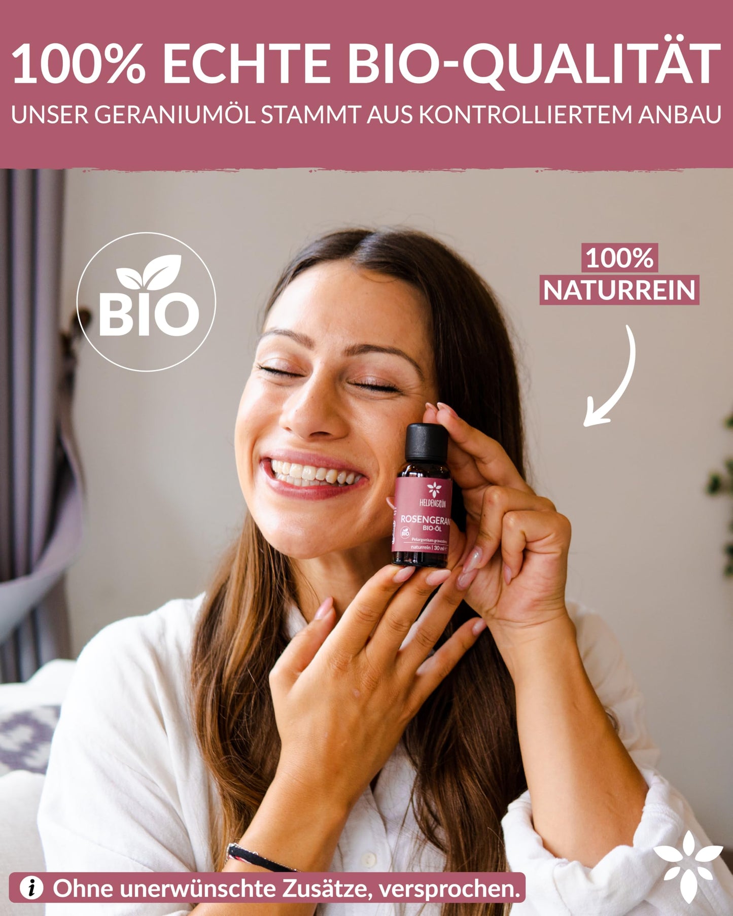 A woman holding a bottle of Heldengrun Organic Essential Oil 30ml rosengeranie