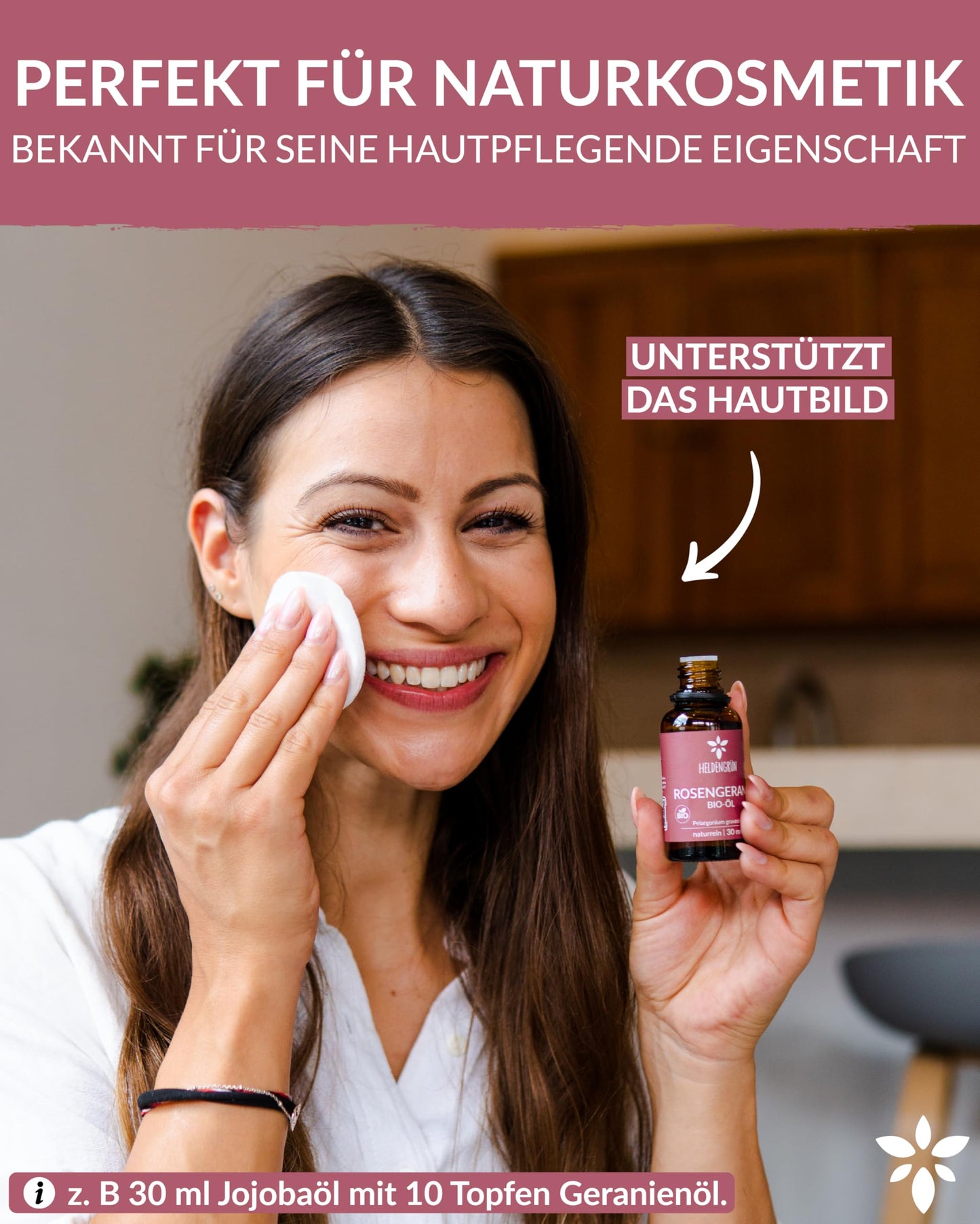 A woman holding a bottle of Heldengrun Organic Essential Oil 30ml rosengeranie