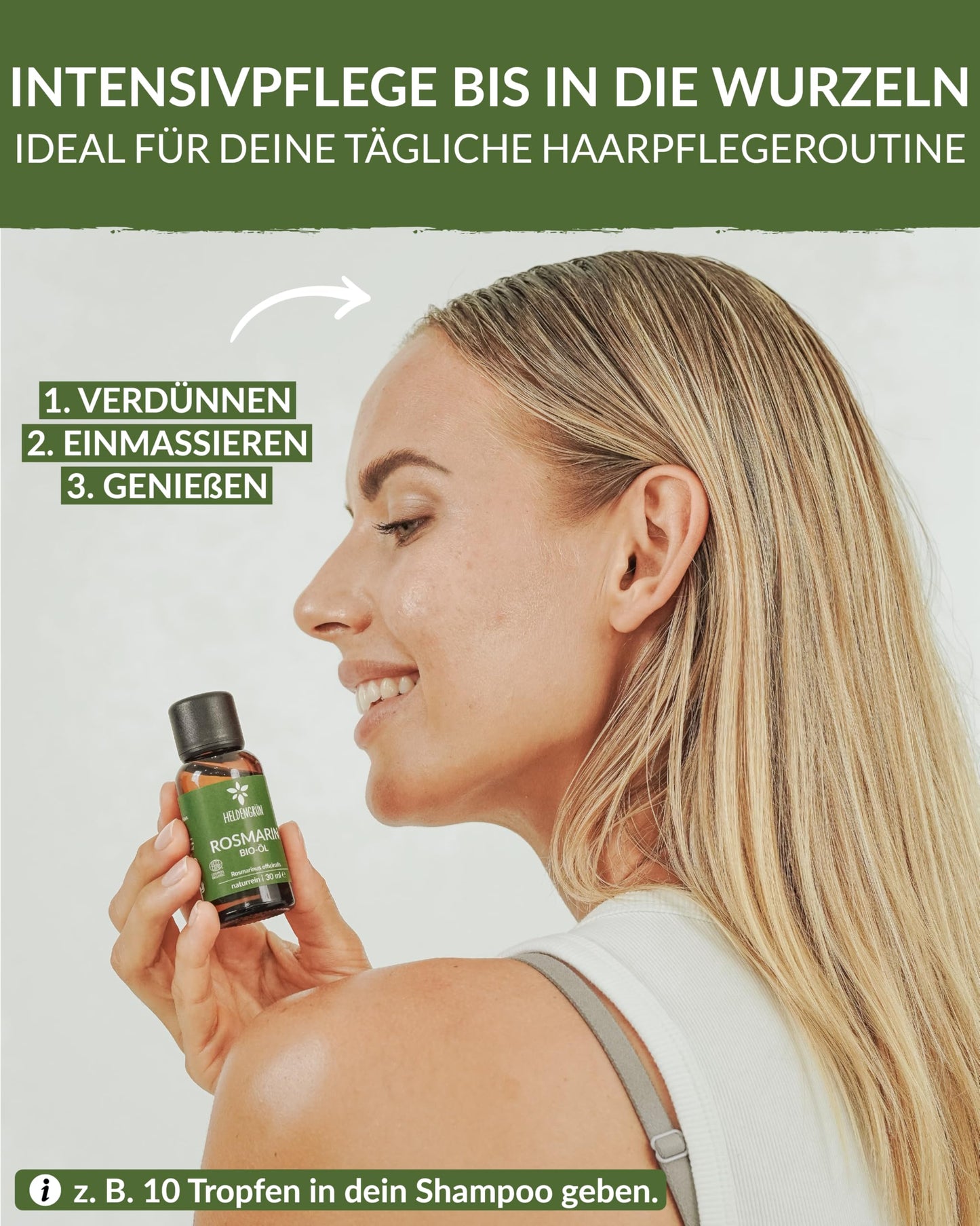 A woman holding a bottle of Heldengrun Organic Essential Oil 30ml rosmarin