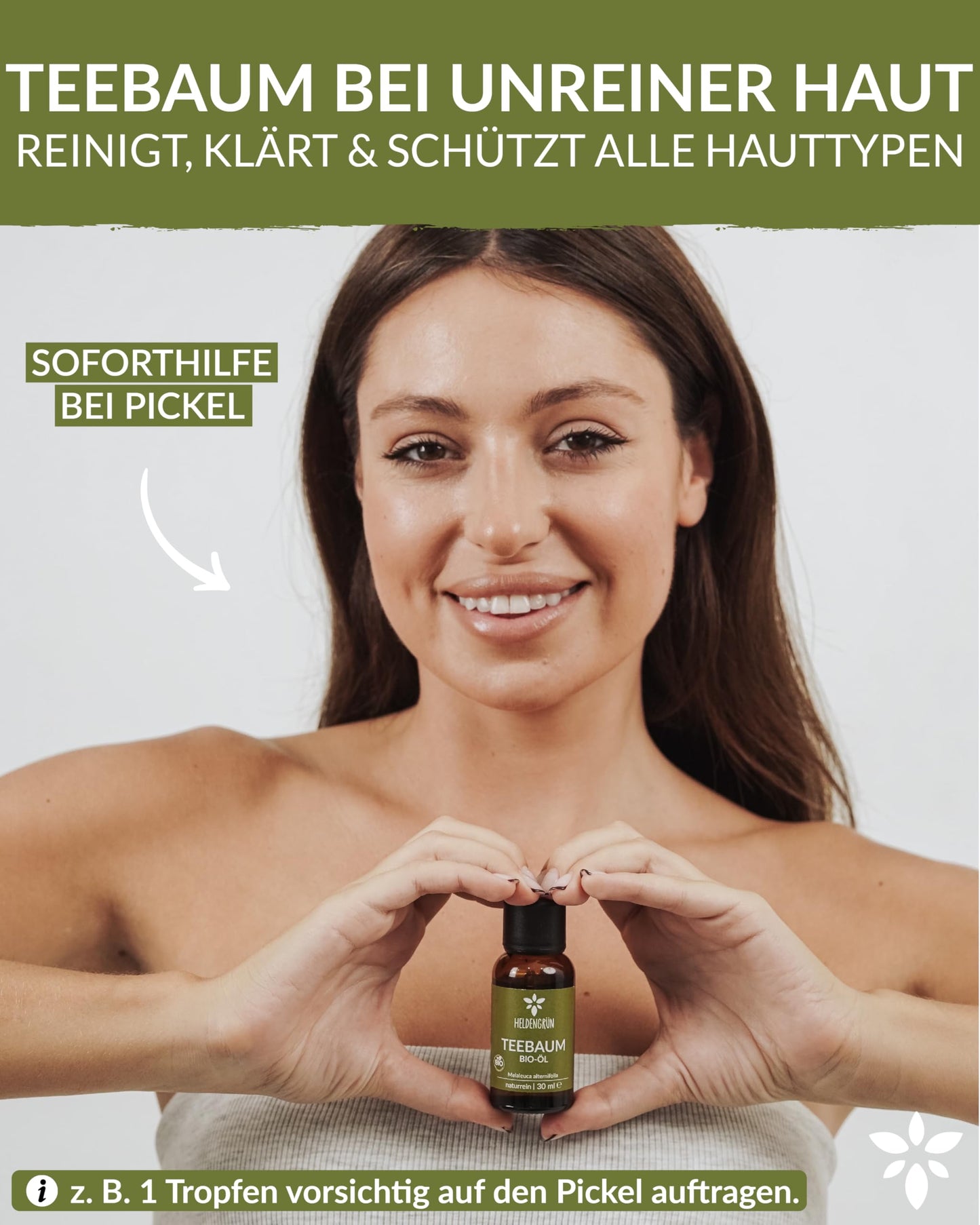 A woman holding a bottle of Heldengrun Organic Essential Oil 30ml teebaum