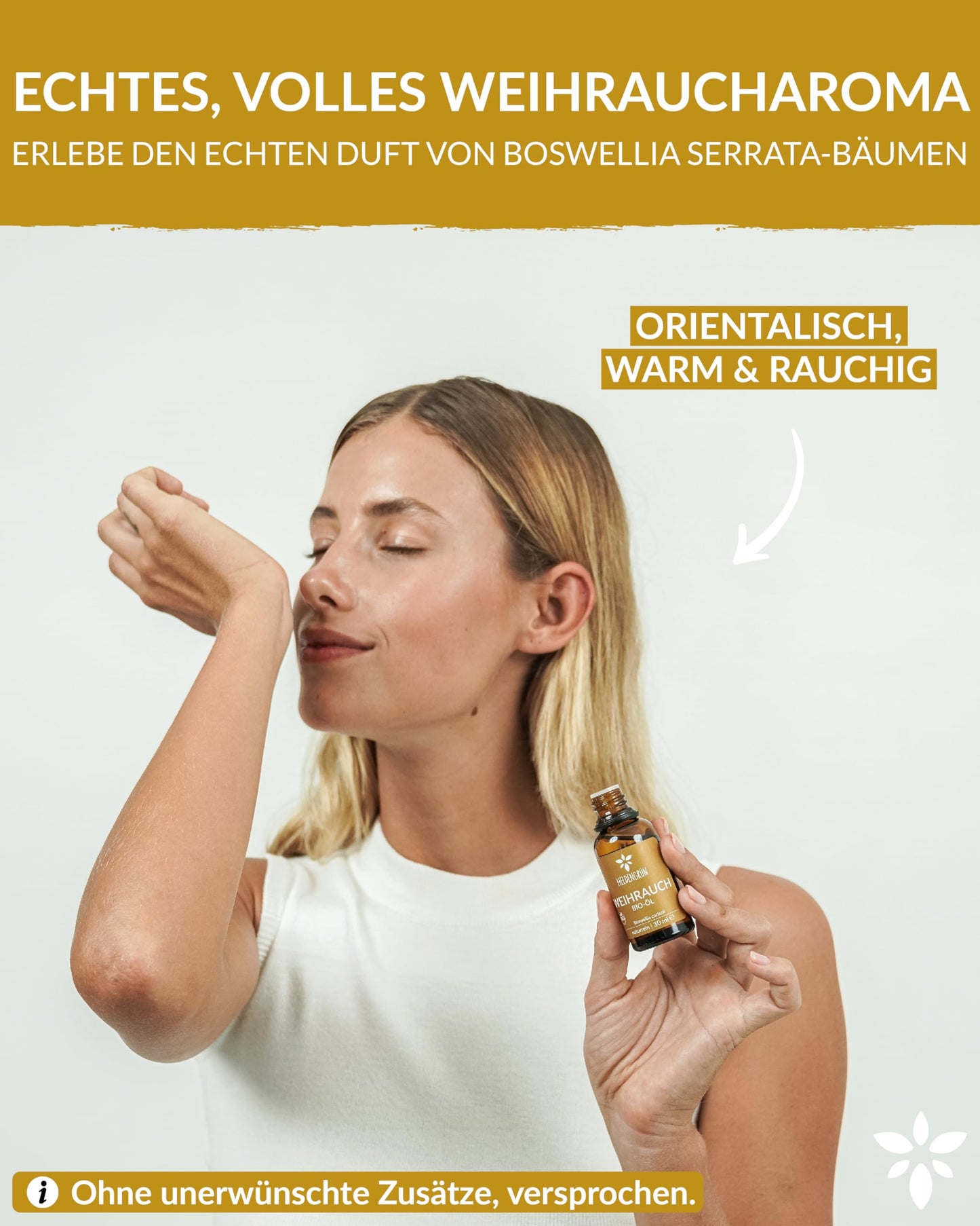 A woman holding a bottle of Heldengrun Organic Essential Oil 30ml weihrauch
