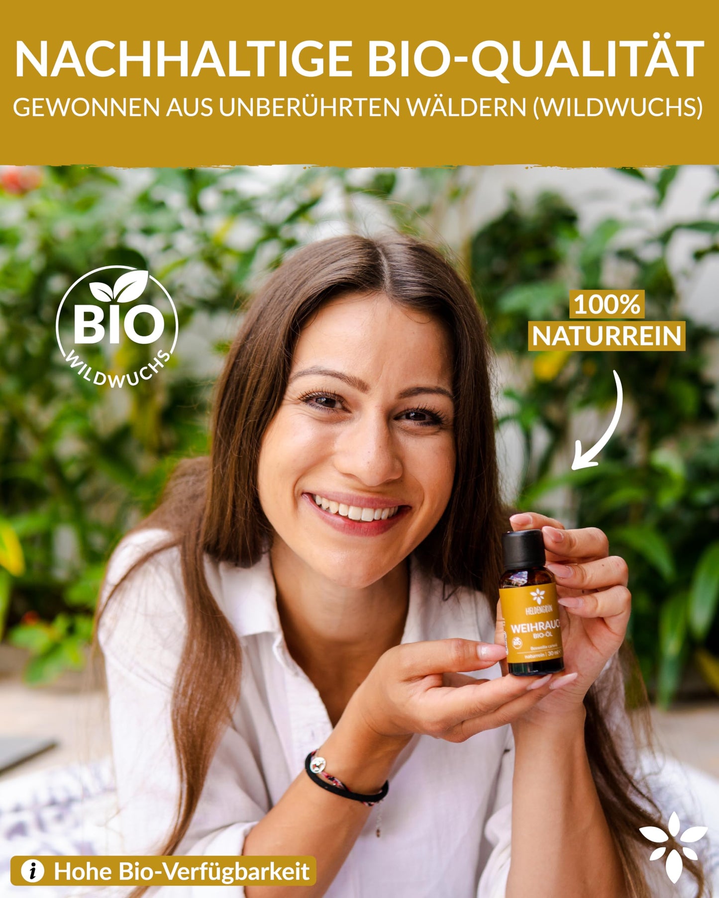 A woman holding a bottle of Heldengrun Organic Essential Oil 30ml weihrauch