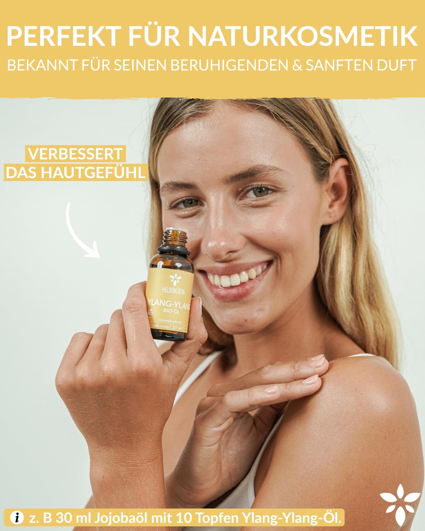 A woman holding a bottle of Heldengrun Organic Essential Oil 30ml ylang-ylang