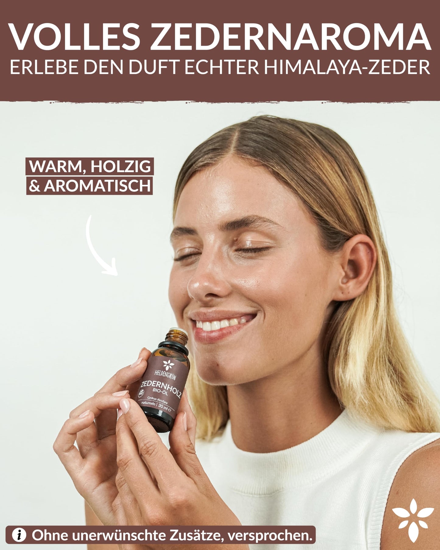 A woman holding a bottle of Heldengrun Organic Essential Oil 30ml zedernholz