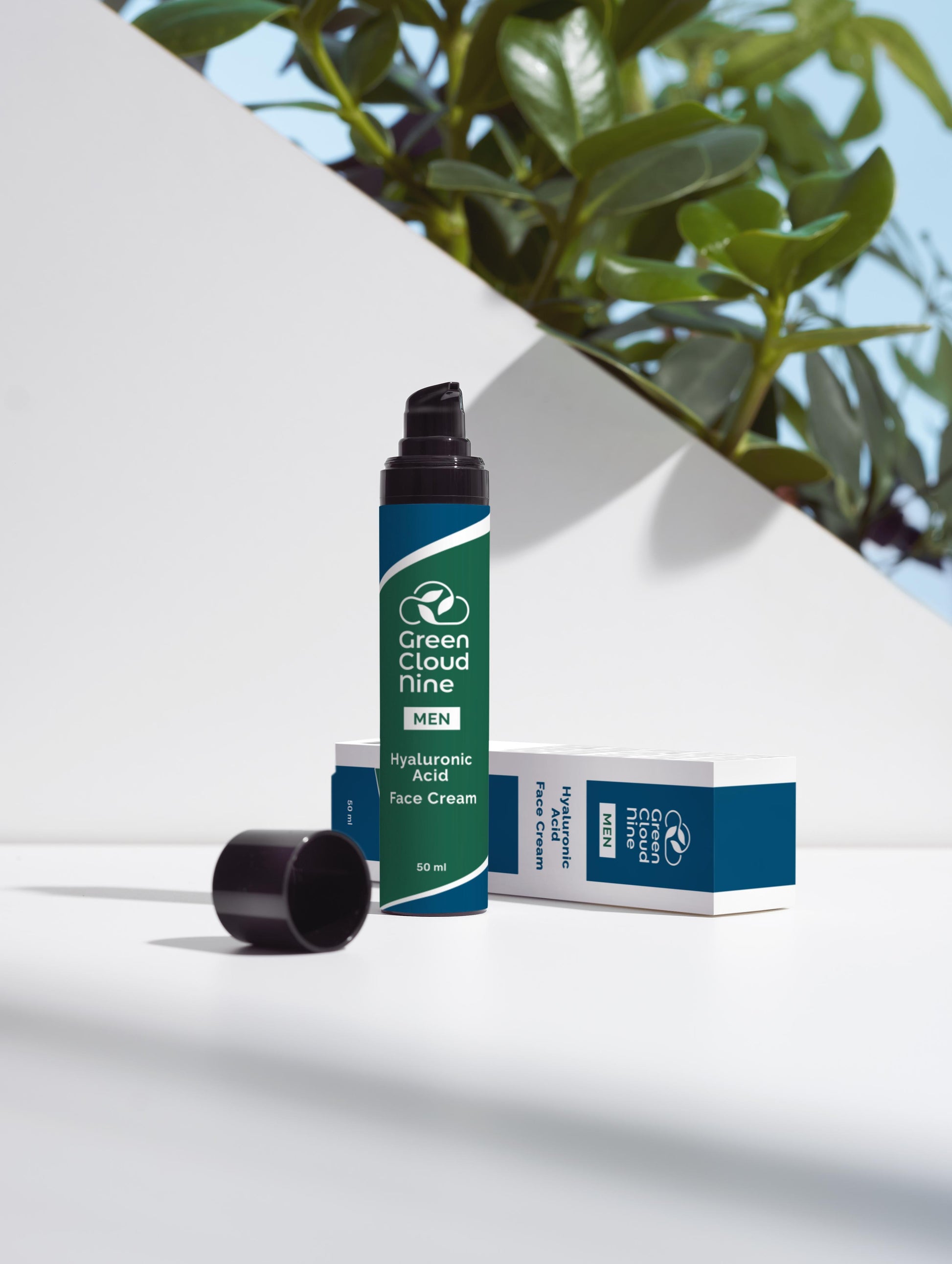 Hyaluronic Acid Face Cream with box in a green/blue pump bottle with Green Cloud Nine Logo, on a white background with plants