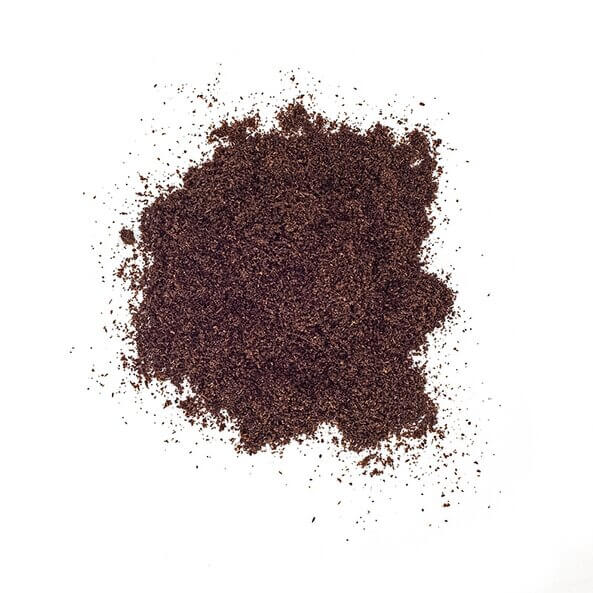 Close-up of organic ground vanilla powder on a white background