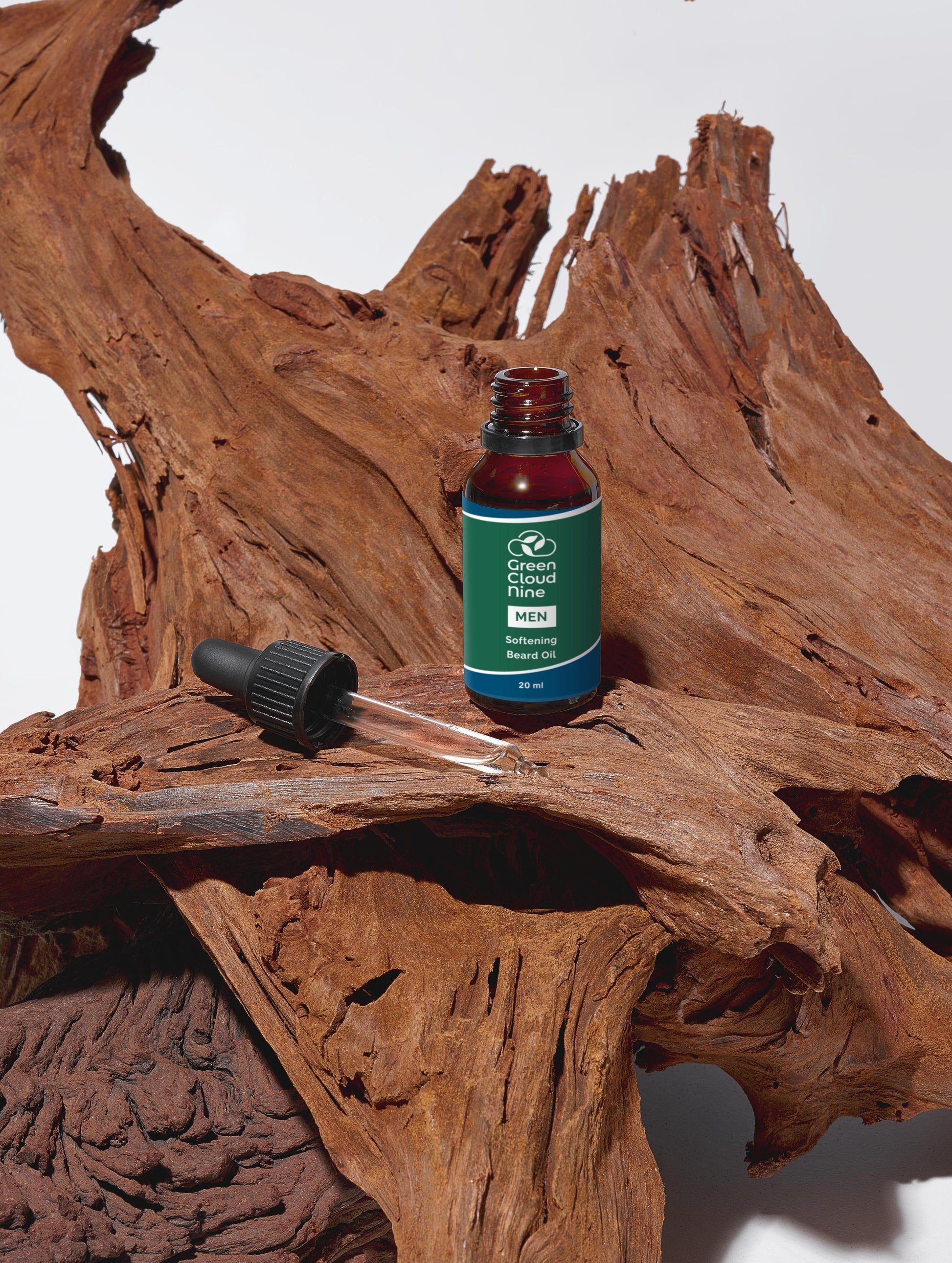 Green Cloud Nine Softening Beard Oil with dropper standing on drifted wood