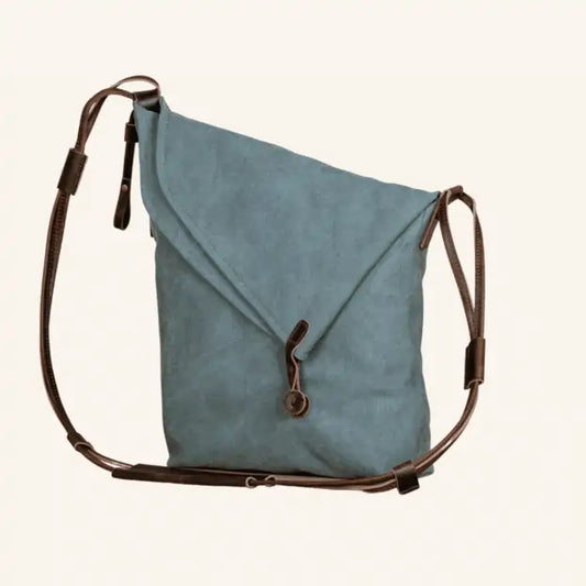 Turquoise canvas and leather handbag with adjustable straps and a loop closure, eco-friendly and handmade.