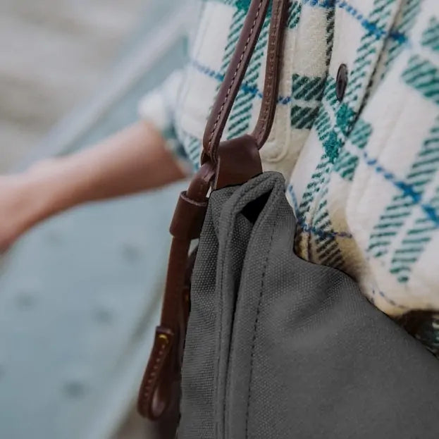 Close-up of Turquoise canvas and leather handbag