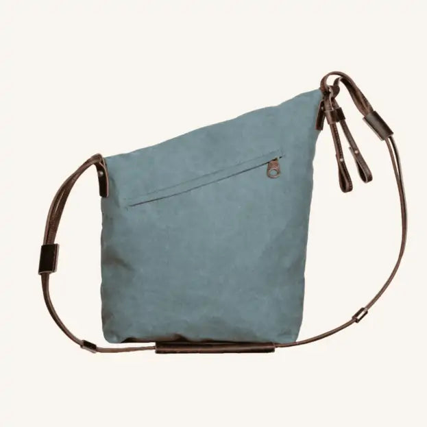 Back of Turquoise canvas and leather handbag with adjustable straps and a loop closure, eco-friendly and handmade.