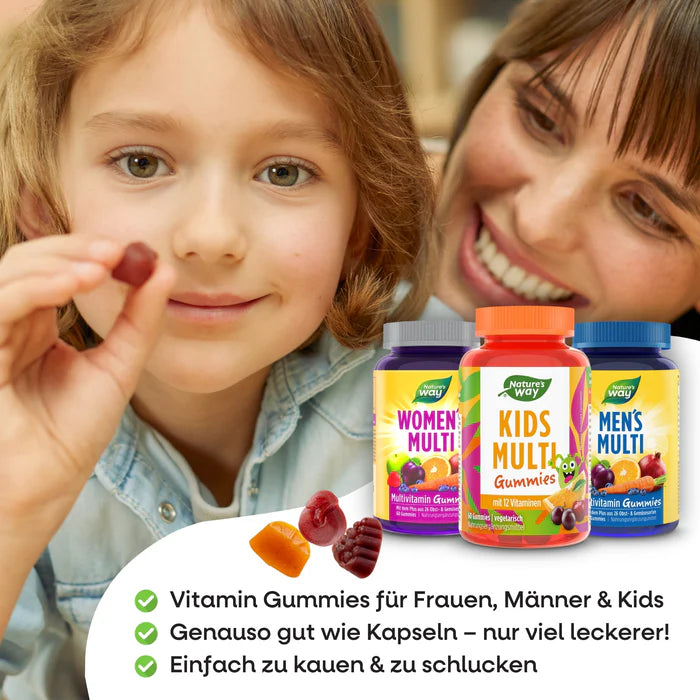 Smiling child holding a vitamin gummy, with mom behind and Nature’s Way Family Set bottles in the foreground.