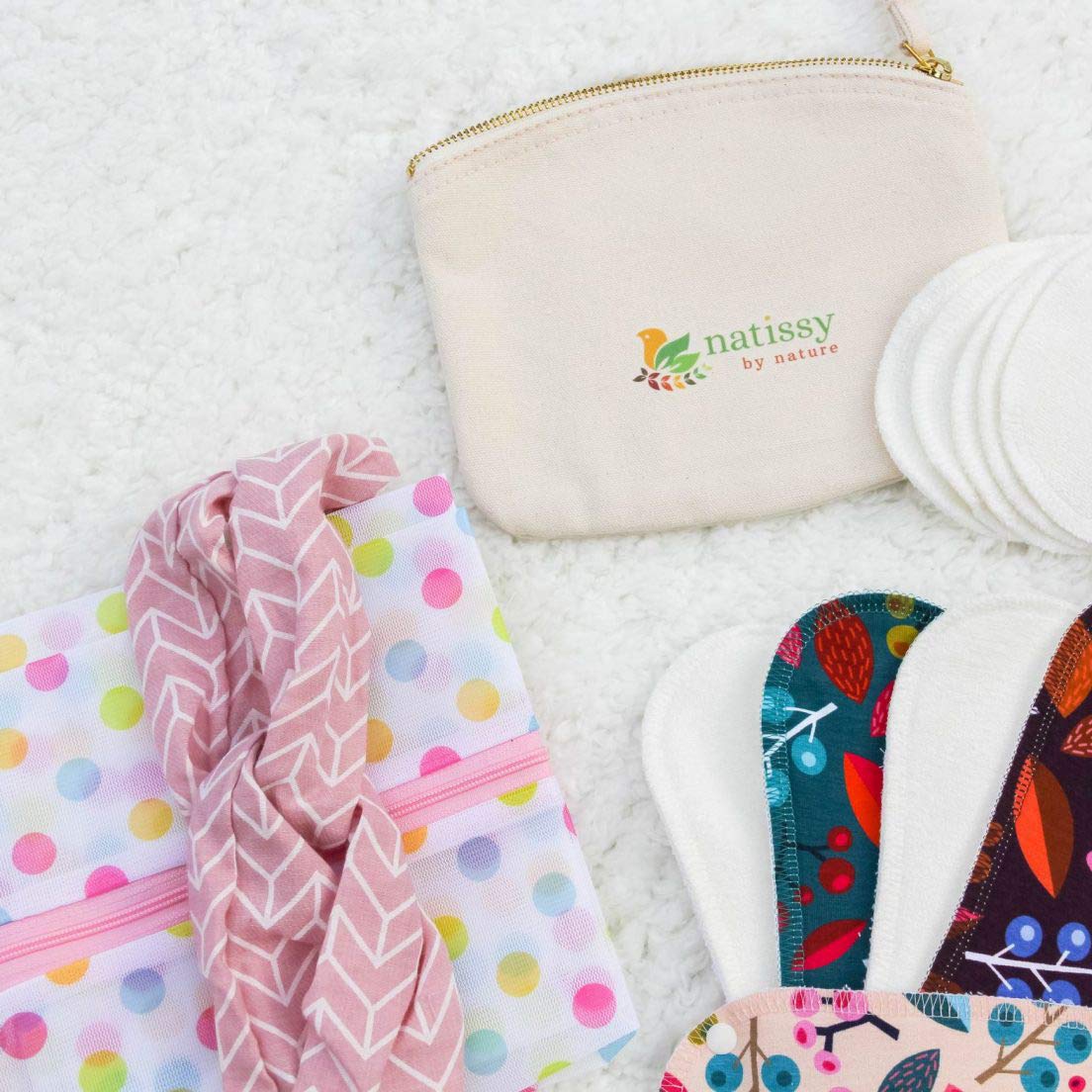 Washable Organic Cotton panty liners with wings lying on a white bed