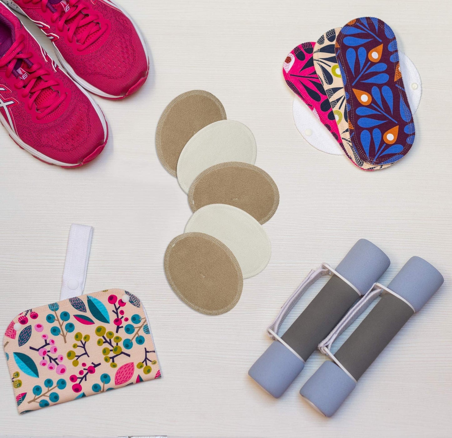 Round inserts, pink sneakers, and hand weights with Washable Organic Cotton panty liners with wings