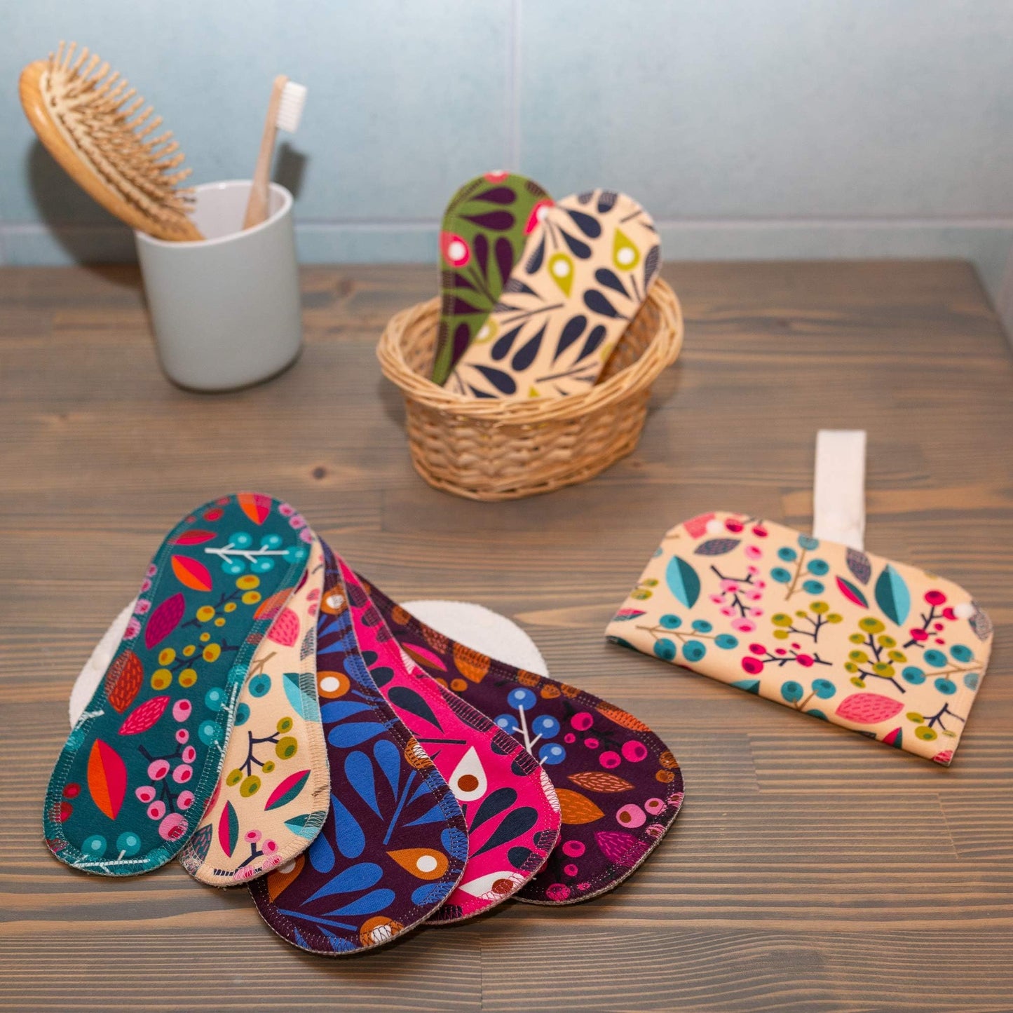 Washable Organic Cotton panty liners with wings on a wooden table