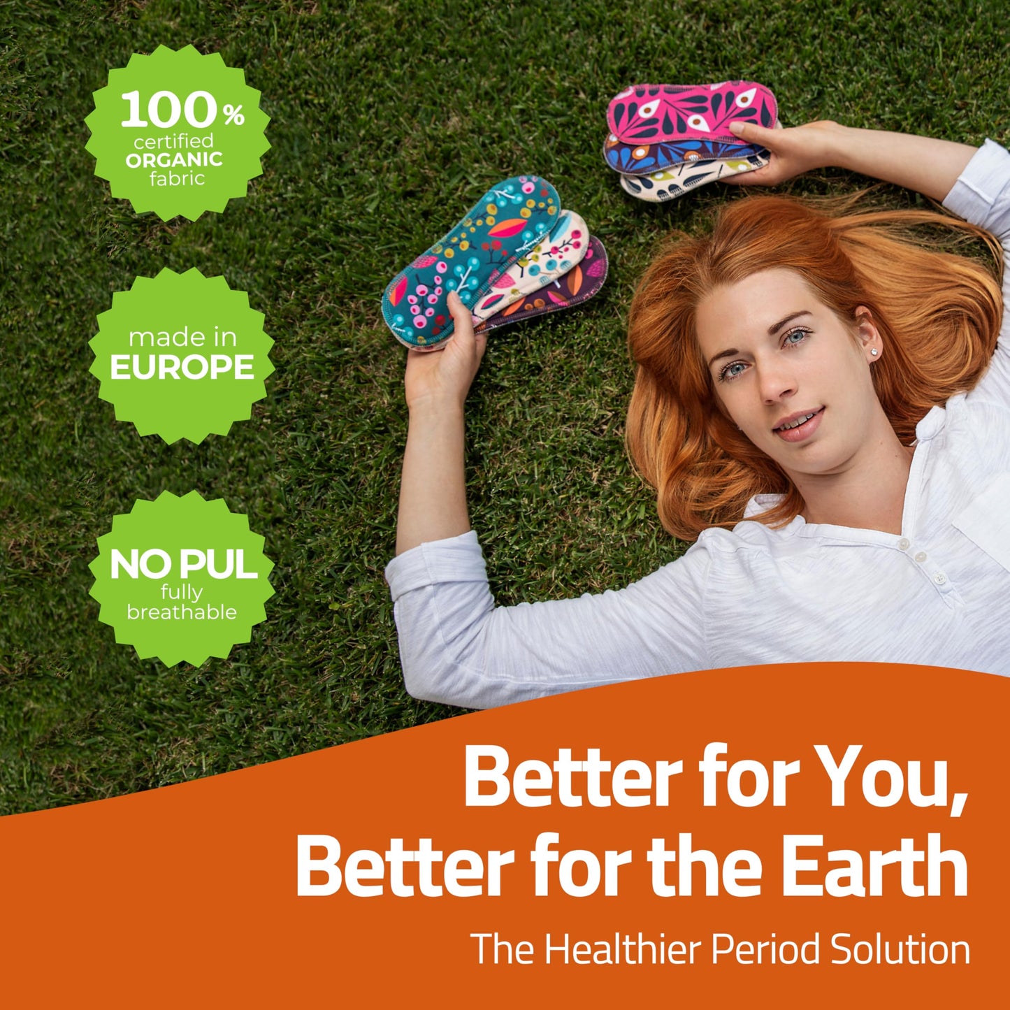 Woman lying on grass, holding colorful Washable Organic Cotton panty liners with wings