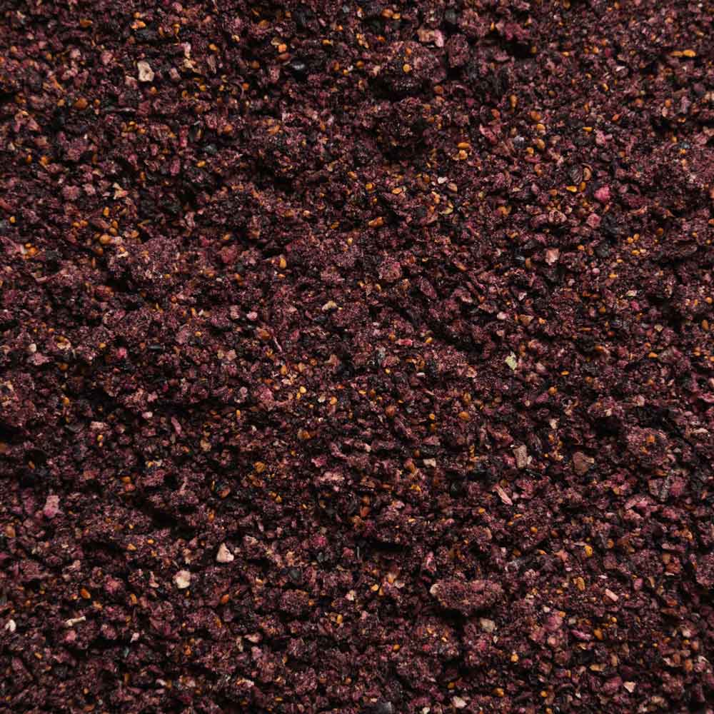 Close-up of freeze-dried organic wild blueberry powder showing its rich texture and deep purple color.