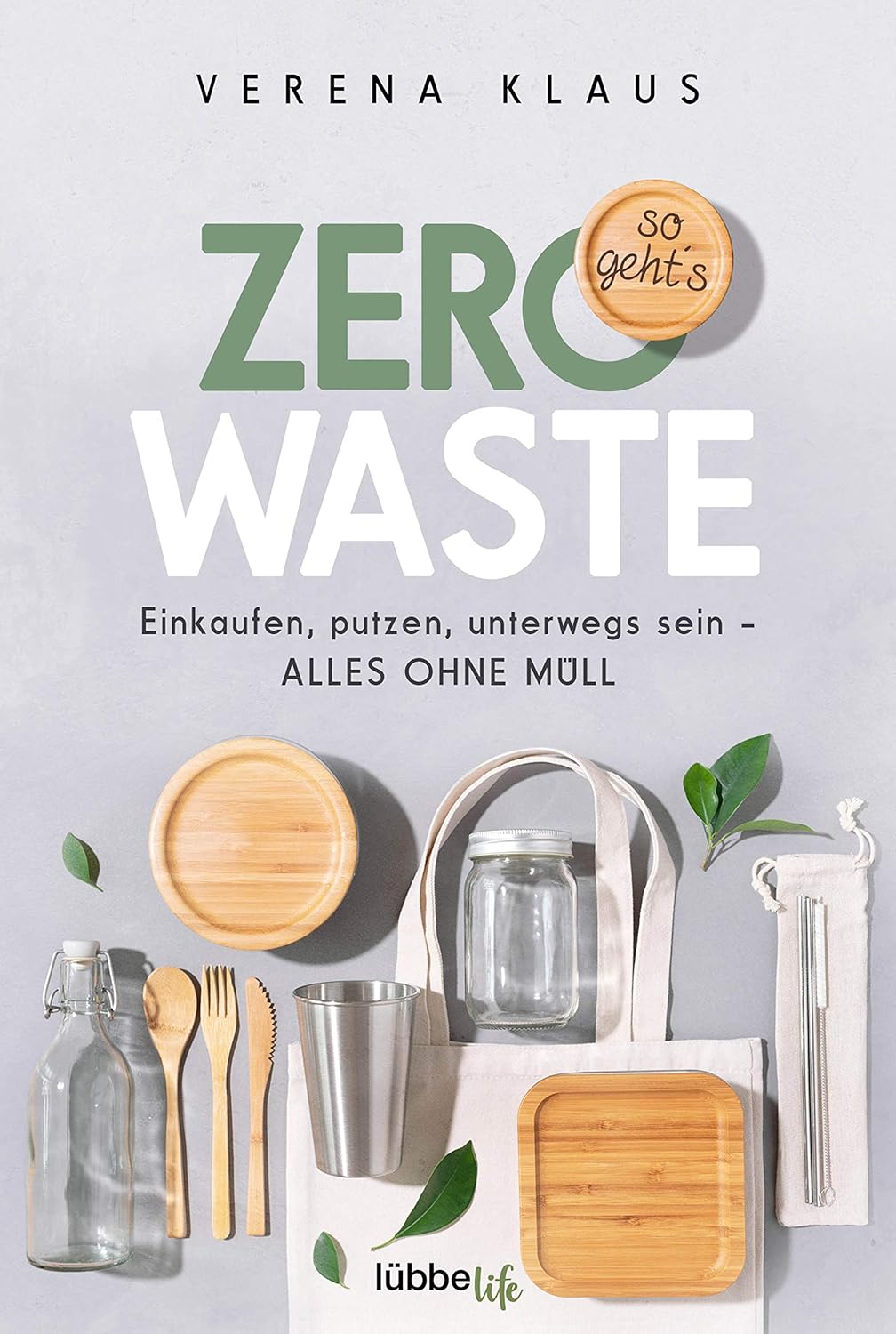 Zero Waste book cover with reusable items: bamboo plates, cutlery, tote bag, jar, and straws on light background.
