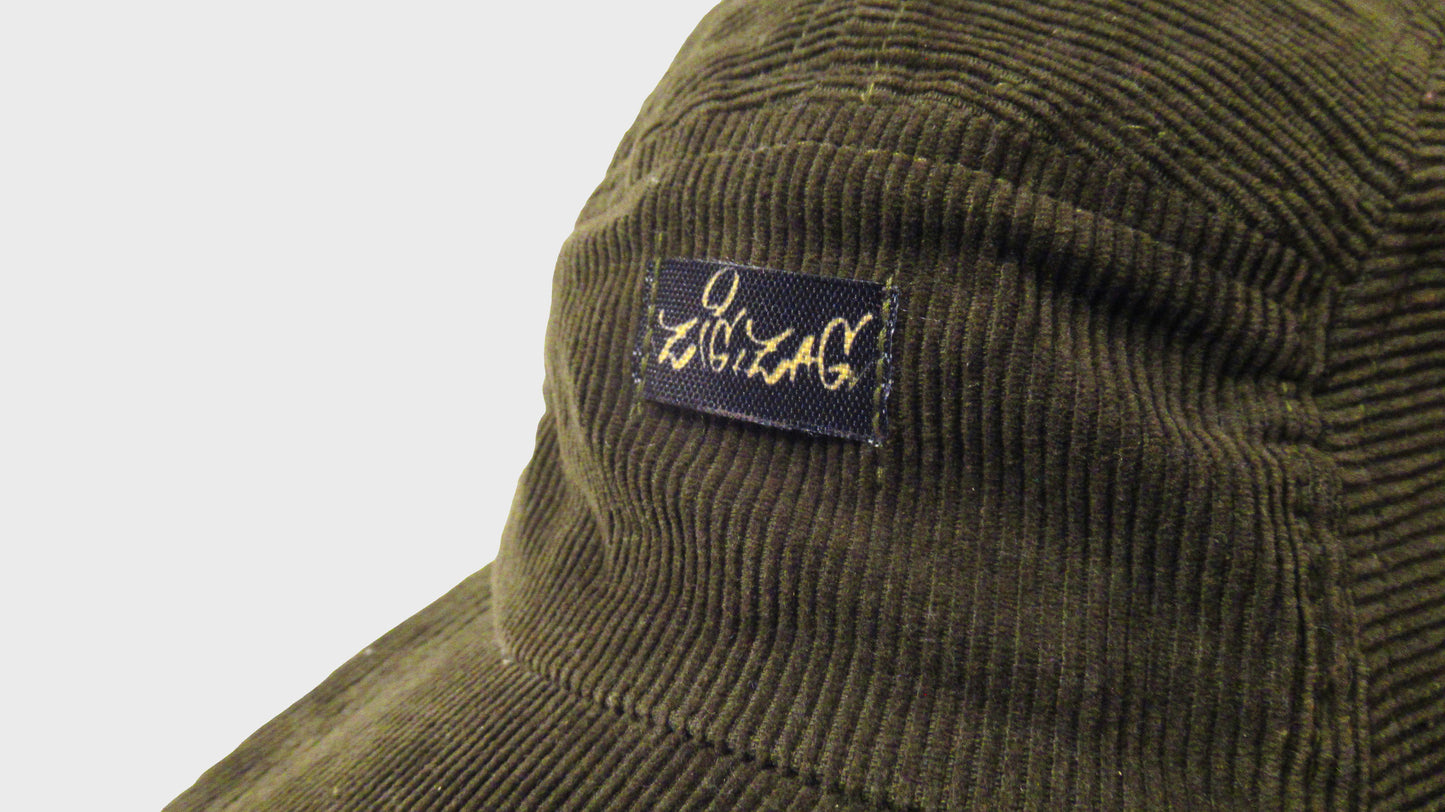 Zig Zag upcycled green army cap. made from repurposed textiles, combining sustainability, durability, and style for an eco-friendly fashion choice