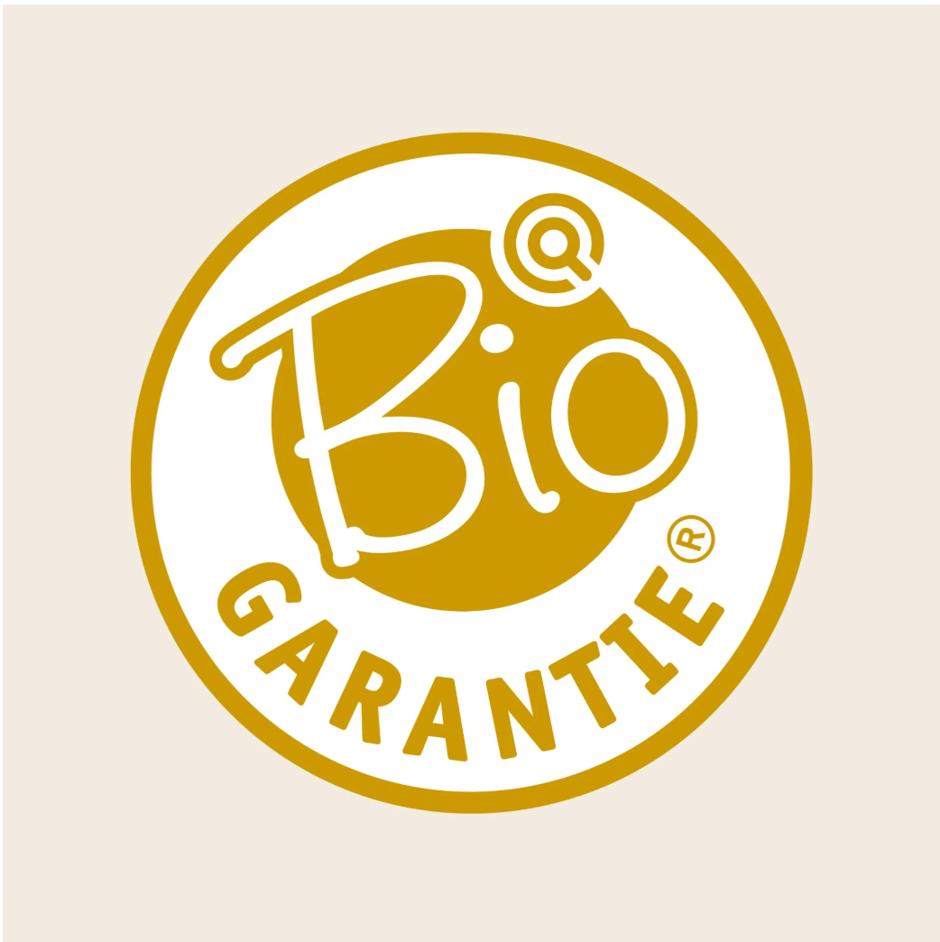 Yellow and white Bio Garantie certification logo on a light beige background