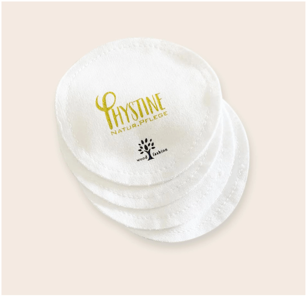 White round Phystine cleansing pads with gold/blue logo on neutral background