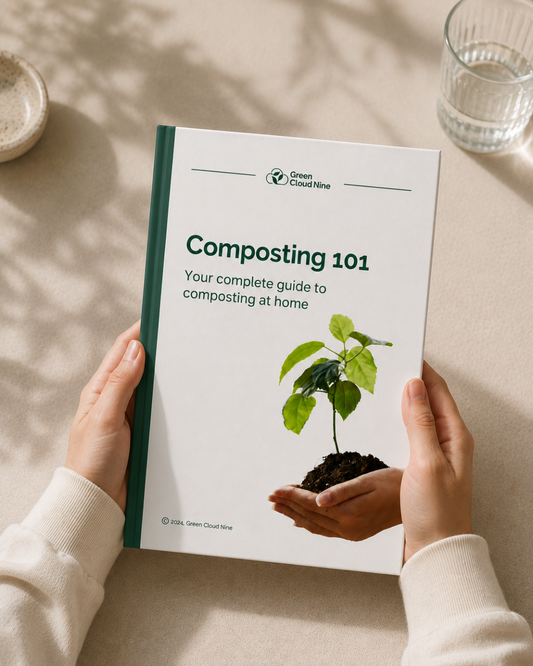 Hands holding a book called Composting 101: your complete guide to composting at home, by Green Cloud Nine