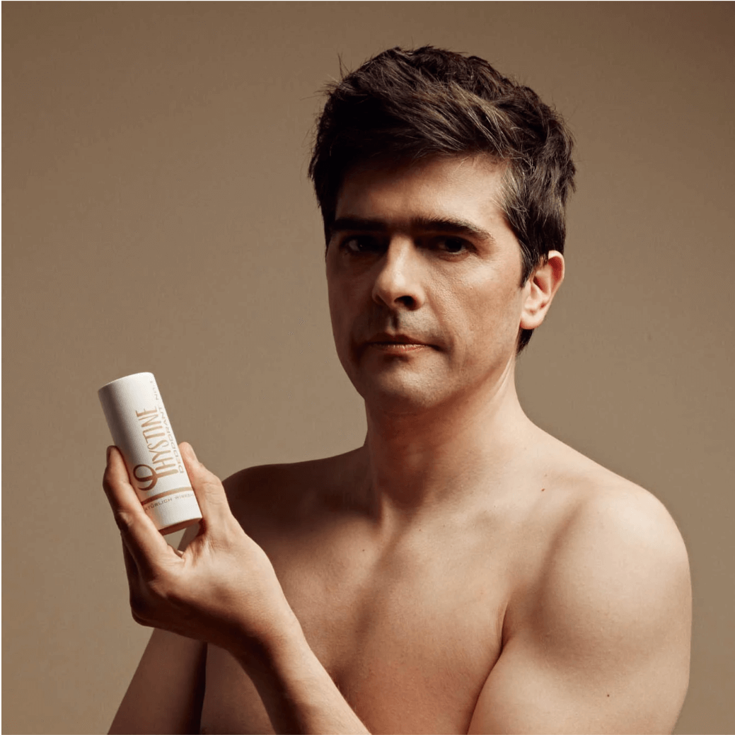 Man holdin Phystine Deodorant No.1 in eco-friendly paper packaging