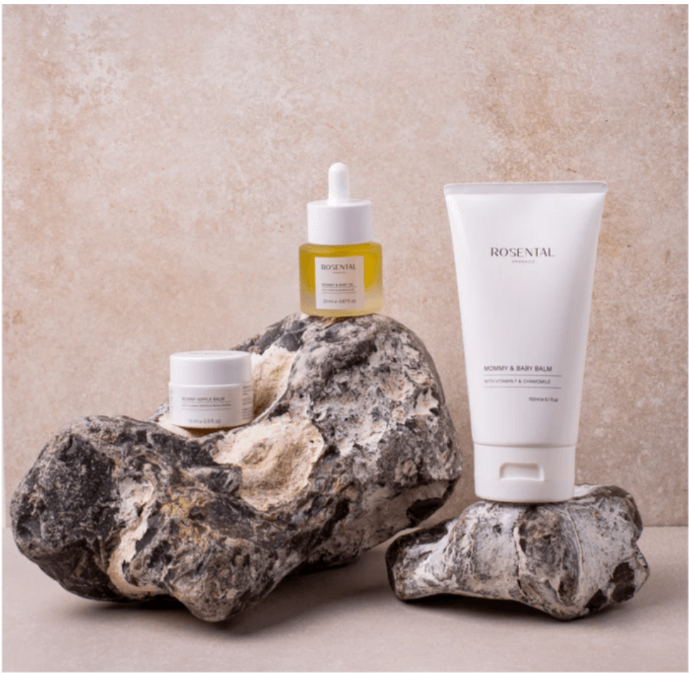 Rosental Mommy & Baby Care Set with balm, nipple balm, and baby oil, made from natural ingredients above stones