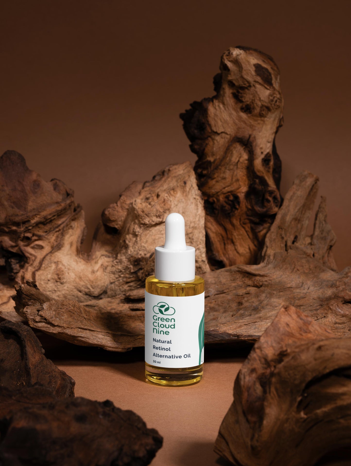 Bottle of Green Cloud Tincture oil with a white dropper on a brown background