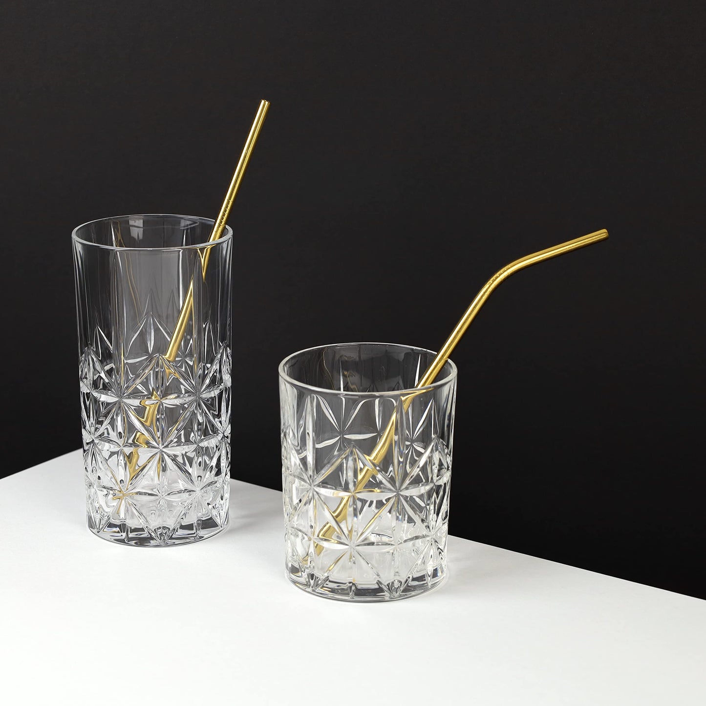 Two crystal glasses with gold stainless steel straws from The Bottle Opener Company. Eco-friendly and reusable.