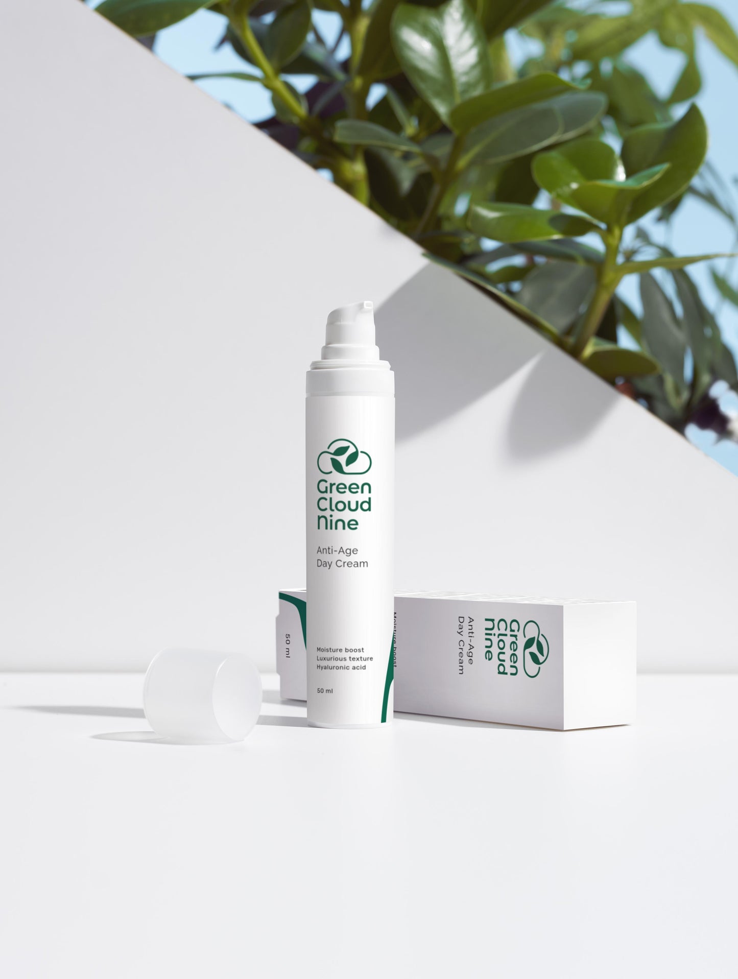 Anti-Age Day Cream with box. White pump with green cloud nine logo on a white background with plants